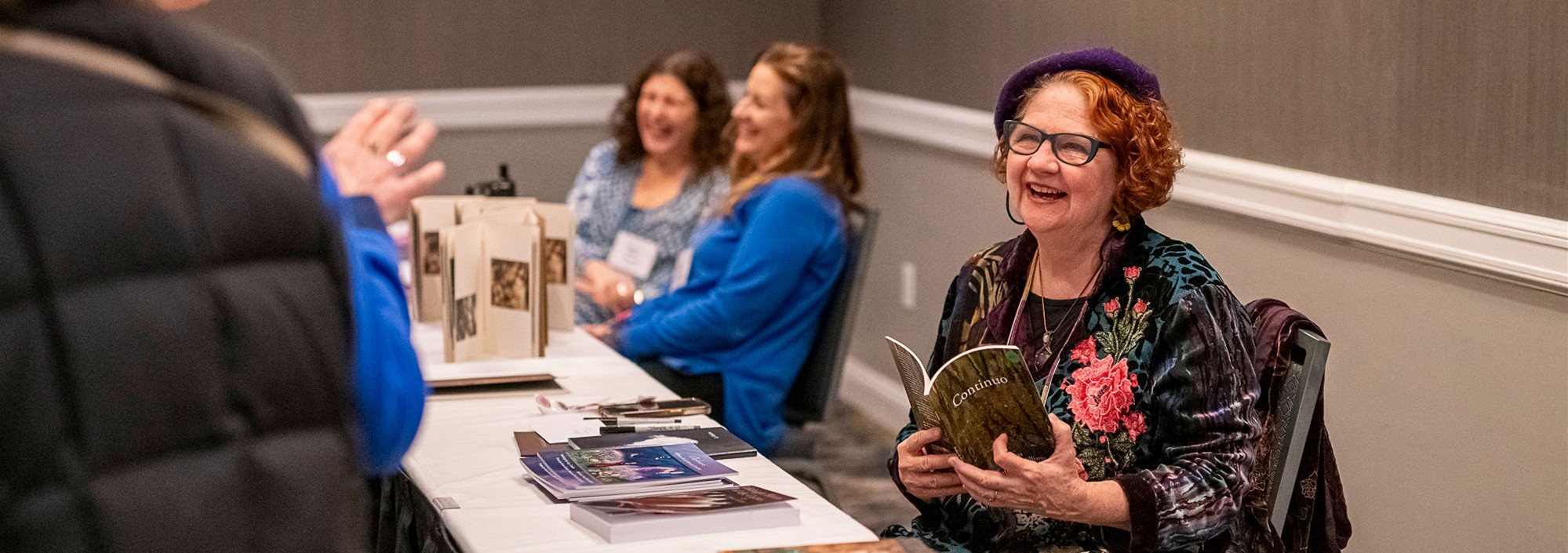 A smiling writer with a book