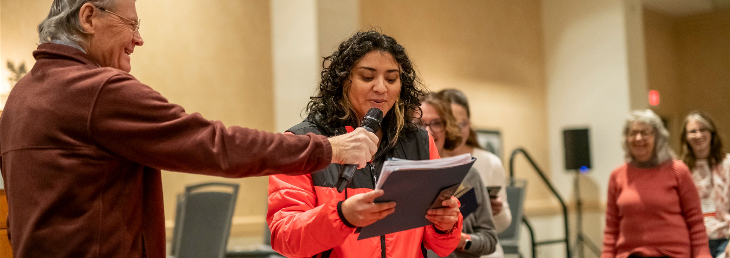Peter Murphy holding a mic for a writer